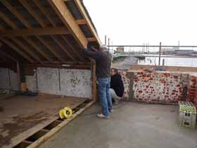 Jim and Asa fixing a steel roof support.